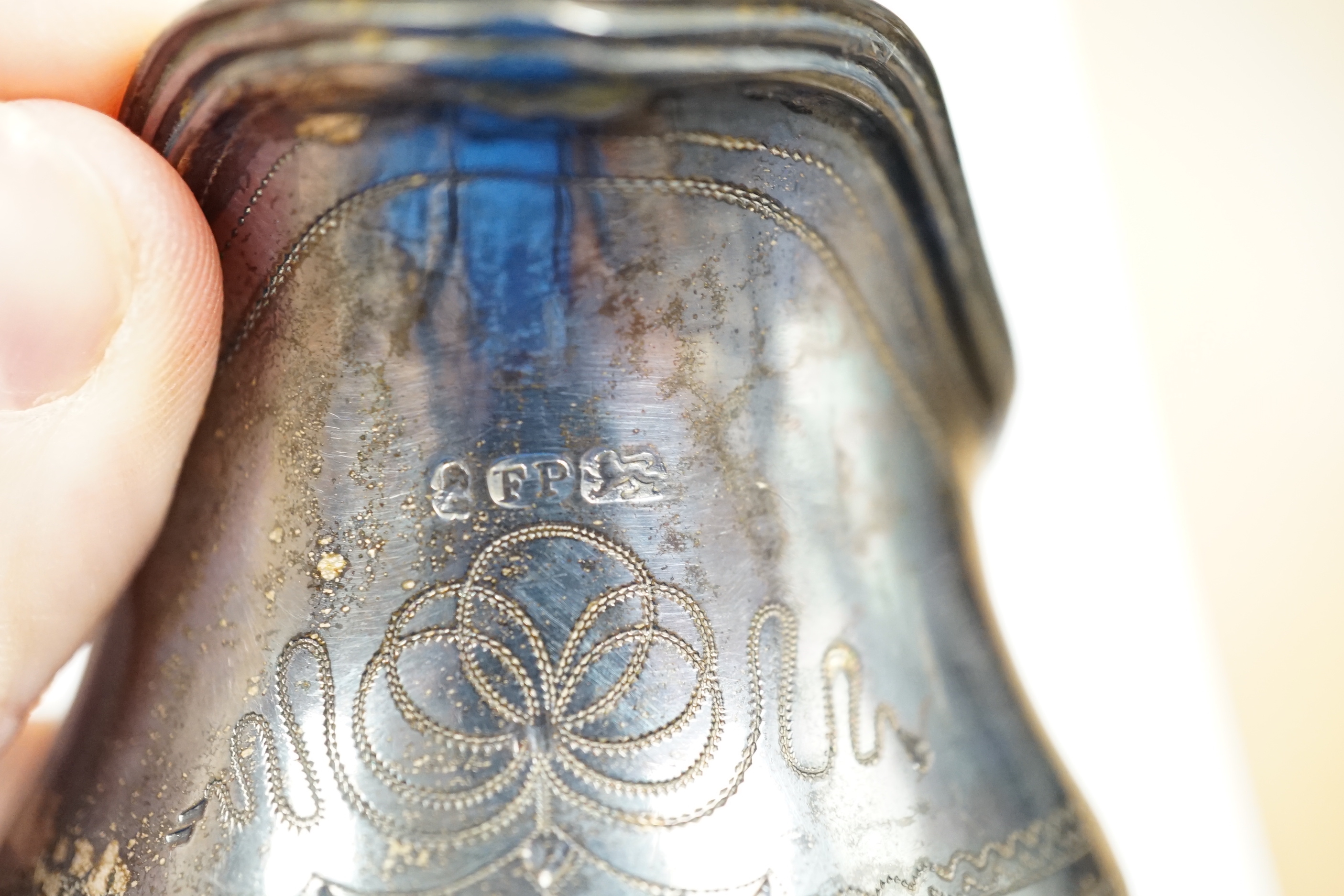 A George III engraved silver helmet shaped cream jug, Francis Purton?, London, circa 1790, height 10.6cm (a.f.), together with a cased set of six George V silver coffee can holders, with glass inserts, Marples & Co, Birm